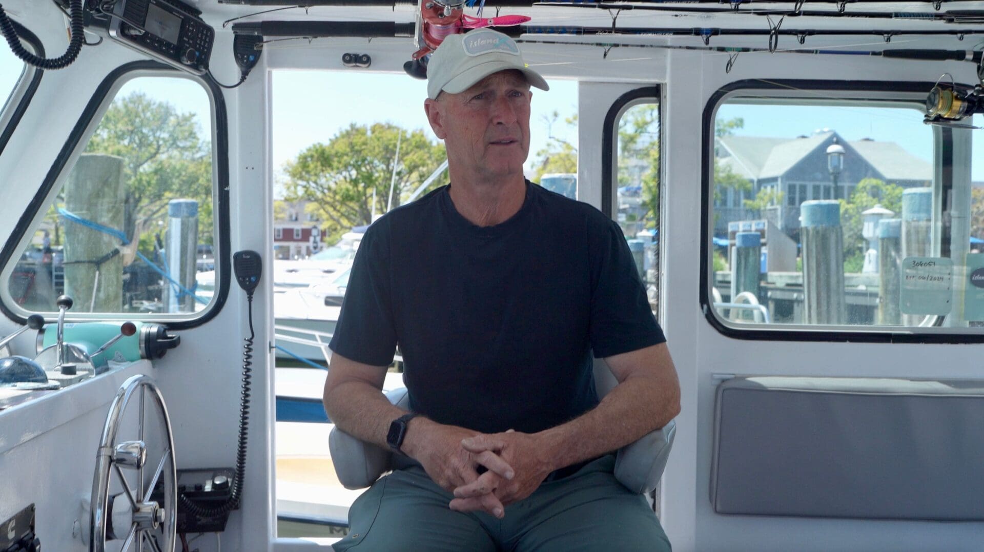 A man sitting on the back of a boat.