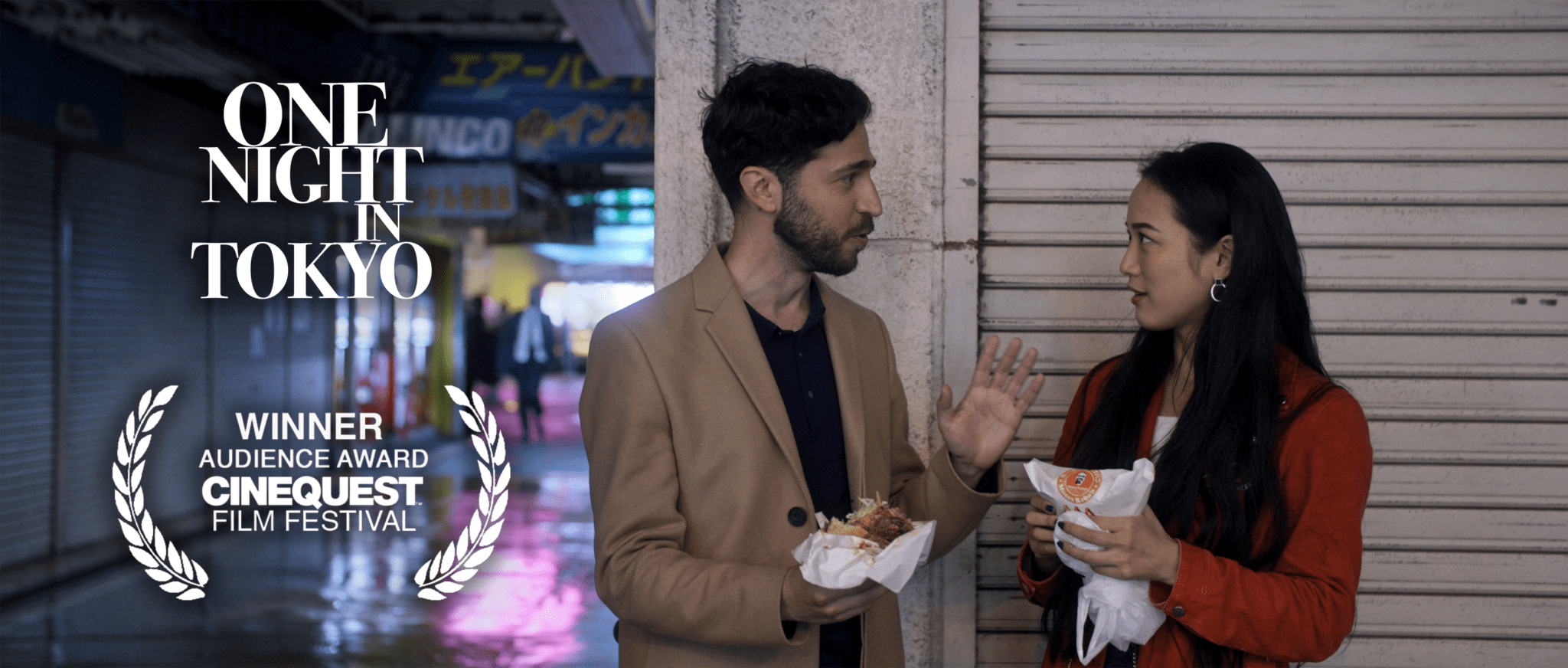 A man in a brown jacket holding food.