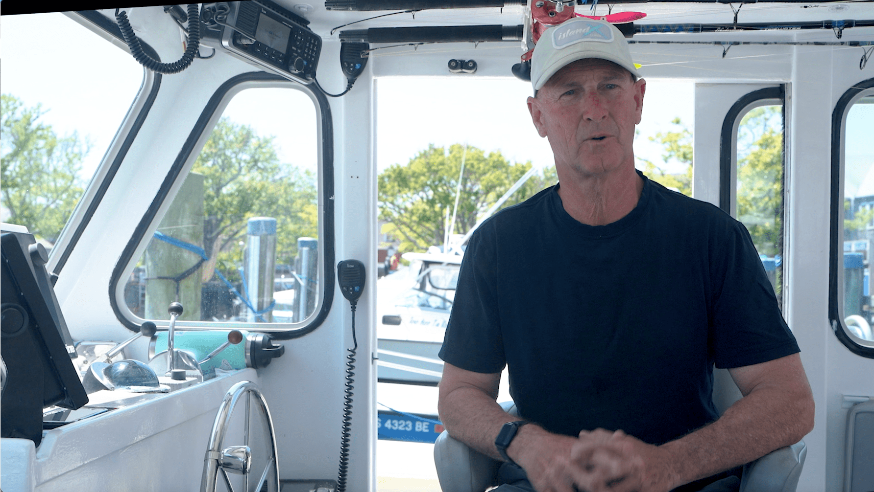 A man sitting in the back of a boat.