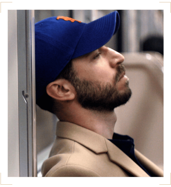 A man with a beard and baseball cap on.