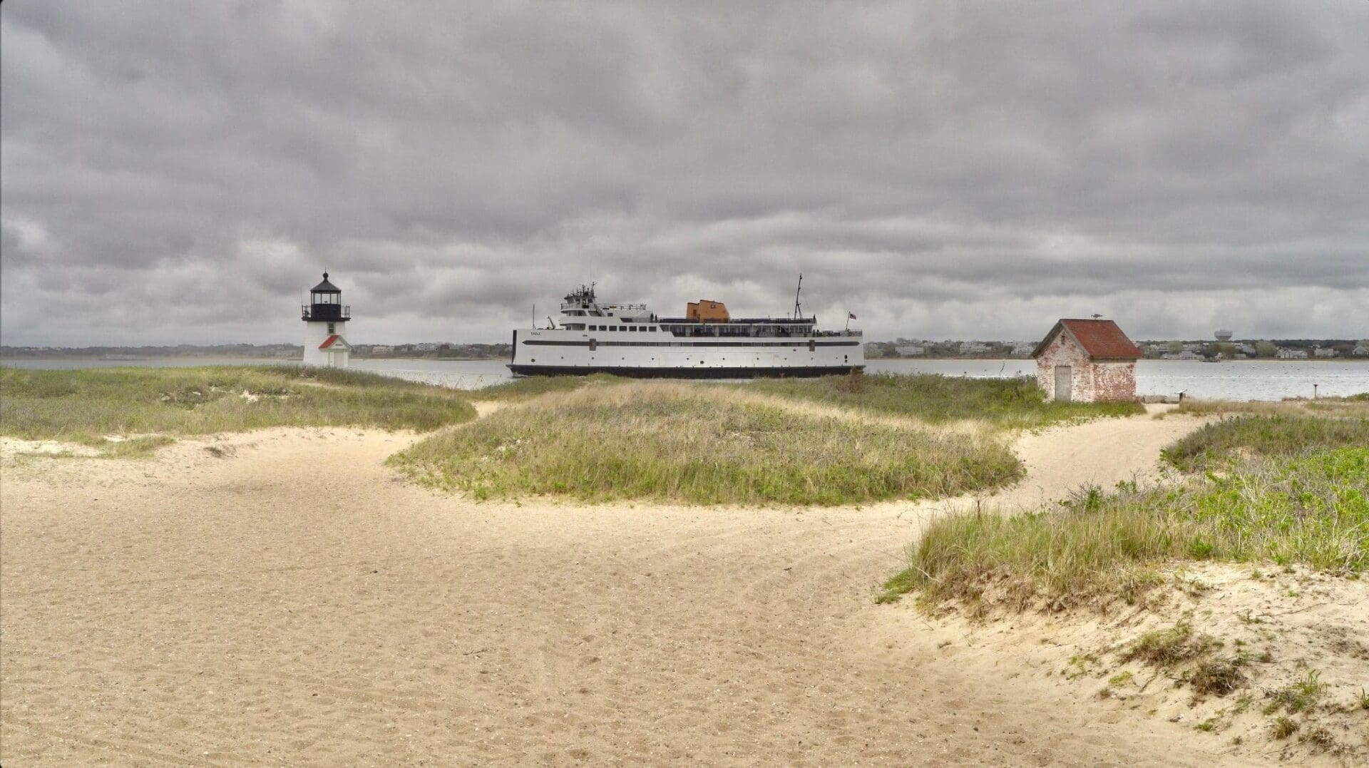 A boat is in the distance on the beach.