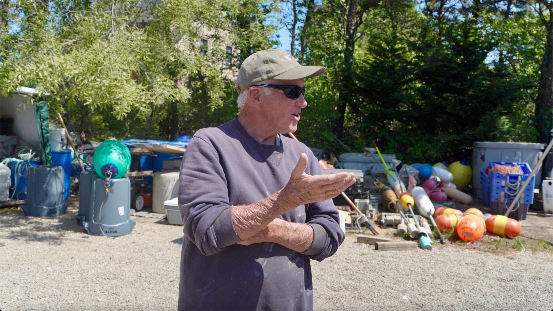 A man standing in front of some trash.